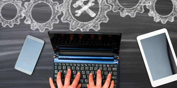 Picture of Laptop and person typing